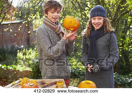 Stock Photo - Children carving pumpkins together. Fotosearch