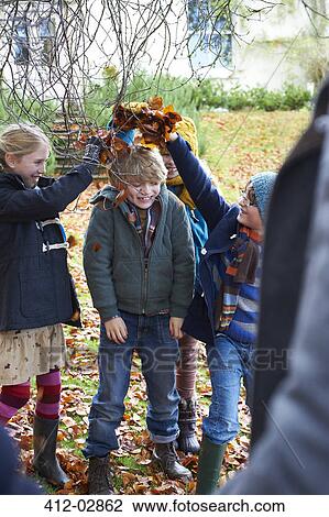 Children playing in autumn leaves outdoors View Large Photo Image Stock Image - Children playing in autumn leaves outdoors. Fotosearch