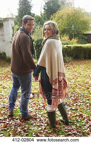 Picture - Couple holding hands outdoors. Fotosearch