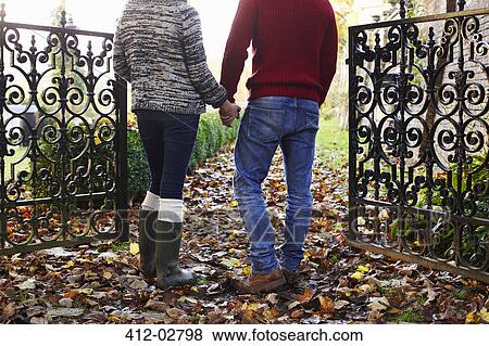 Stock Photo - Couple holding hands outdoors. Fotosearch