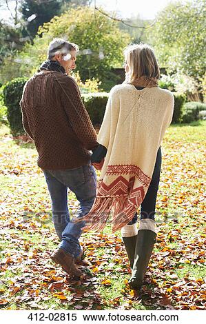 Couple holding hands outdoors View Large Photo Image Stock Photography - Couple holding hands outdoors. Fotosearch