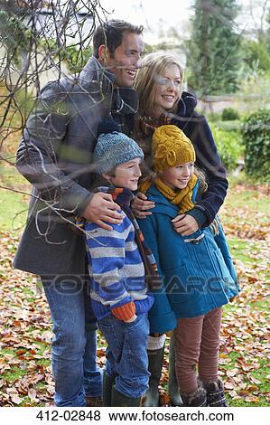Stock Photo - Family smiling together outdoors. Fotosearch