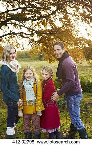 Stock Photography - Family smiling together outdoors. Fotosearch