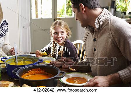 Father and daughter eating together at table View Large Photo Image Stock Image - Father and daughter eating together at table. Fotosearch