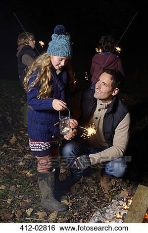 Father and daughter playing with sparkler View Large Photo Image Stock Photograph - Father and daughter playing with sparkler. Fotosearch
