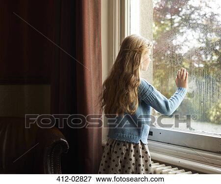 Stock Photo - Girl looking out window. Fotosearch