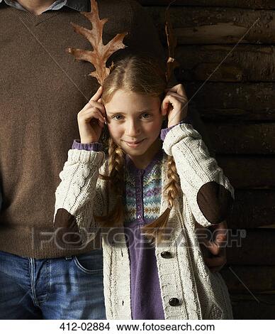 Girl using leaves as antlers View Large Photo Image Picture - Girl using leaves as antlers. Fotosearch