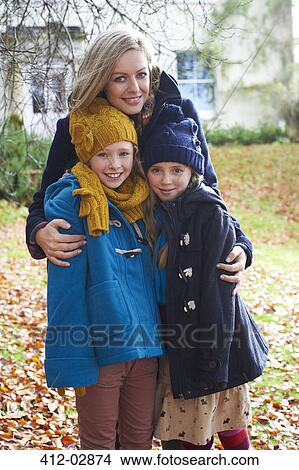Mother and children smiling outdoors View Large Photo Image Picture - Mother and children smiling outdoors. Fotosearch