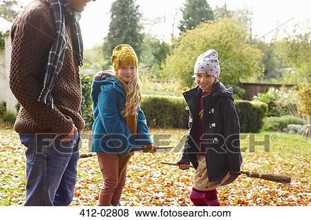 Smiling girls riding brooms outdoors View Large Photo Image Stock Photo - Smiling girls riding brooms outdoors. Fotosearch