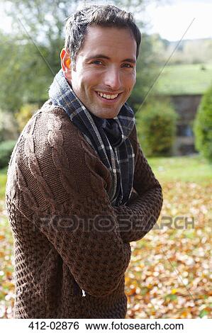 Smiling man standing outdoors View Large Photo Image Stock Photograph - Smiling man standing outdoors. Fotosearch