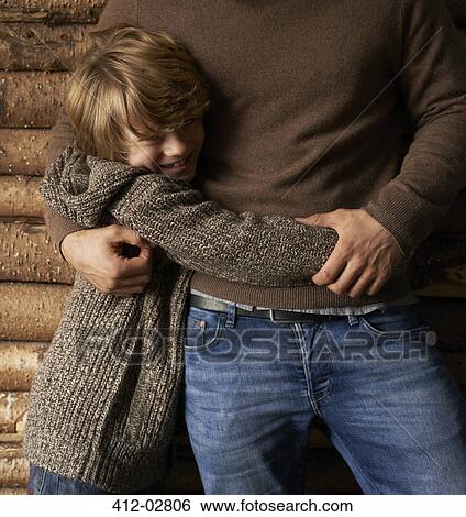 Smiling son hugging father View Large Photo Image Stock Photograph - Smiling son hugging father. Fotosearch