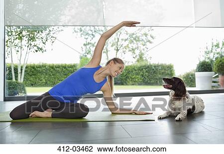 Dog sitting with woman practicing yoga View Large Photo Image Stock Image - Dog sitting with woman practicing yoga. Fotosearch