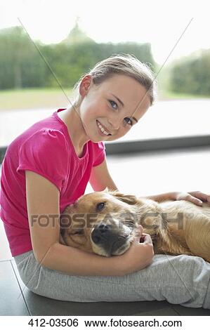 Girl relaxing with dog on floor View Large Photo Image Stock Photograph - Girl relaxing with dog on floor. Fotosearch
