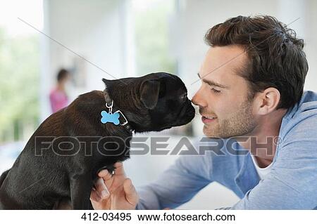 Man and dog touching noses indoors View Large Photo Image Stock Photography - Man and dog touching noses indoors. Fotosearch