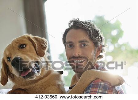 Smiling man petting dog indoors View Large Photo Image Stock Image - Smiling man petting dog indoors. Fotosearch