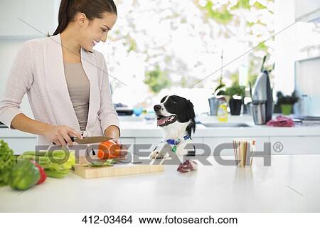 Picture - Woman chopping vegetables in kitchen. Fotosearch