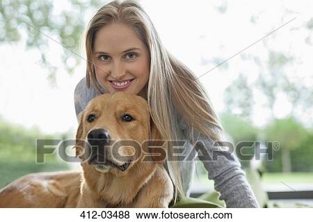 Woman relaxing with dog indoors View Large Photo Image Stock Photo - Woman relaxing with dog indoors. Fotosearch