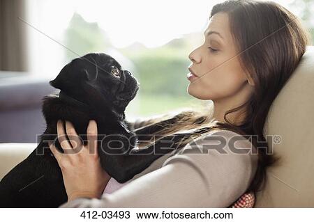 Woman relaxing with dog on sofa View Large Photo Image Stock Image - Woman relaxing with dog on sofa. Fotosearch