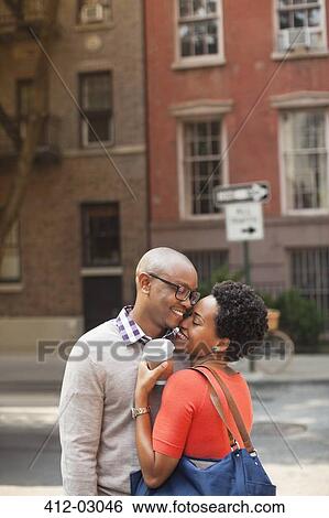 Stock Photograph - Couple hugging on city street. Fotosearch