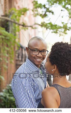 Couple hugging on city street View Large Photo Image Stock Photograph - Couple hugging on city street. Fotosearch