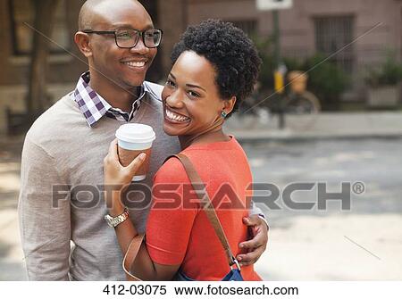 Stock Photography - Couple hugging on city street. Fotosearch