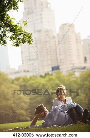 Stock Photography - Couple relaxing in urban park. Fotosearch