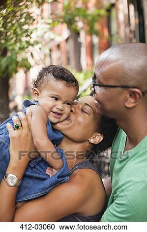 Family hugging on city street View Large Photo Image Stock Image - Family hugging on city street. Fotosearch
