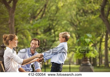 Picture - Family playing together in park. Fotosearch