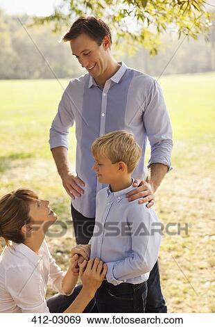 Stock Photo - Family relaxing together in park. Fotosearch