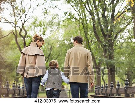 Stock Photograph - Family walking together in park. Fotosearch
