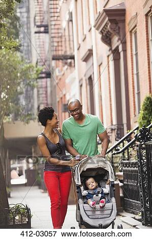 Stock Photo - Family walking together on city street. Fotosearch