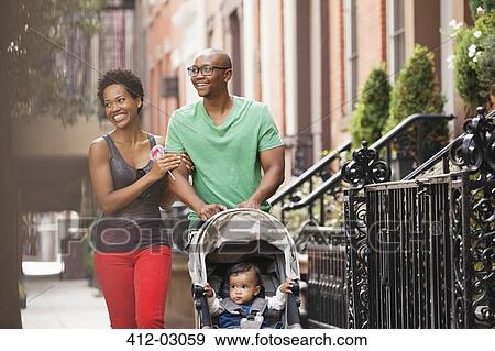 Family walking together on city street View Large Photo Image Stock Photo - Family walking together on city street. Fotosearch