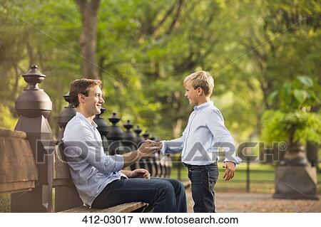 Stock Photo - Father and son in urban park. Fotosearch