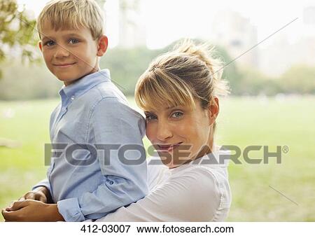 Stock Photo - Mother and son relaxing in urban park. Fotosearch