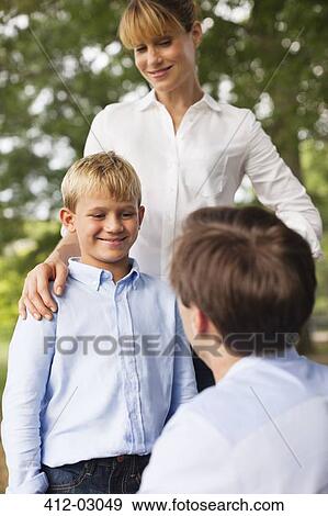Mother, father and son talking in park View Large Photo Image Stock Photo - Mother, father and son talking in park. Fotosearch