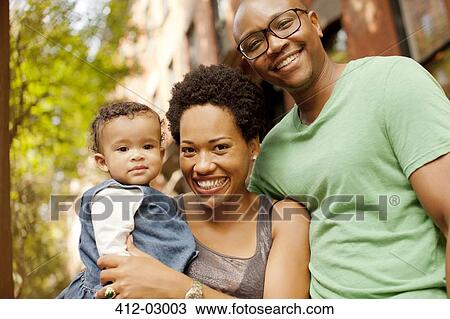 Smiling family standing outdoors View Large Photo Image Stock Image - Smiling family standing outdoors. Fotosearch