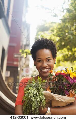 Woman holding bag of groceries View Large Photo Image Stock Image - Woman holding bag of groceries. Fotosearch