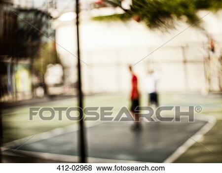 Blurred view of men on basketball court View Large Photo Image Stock Photo - Blurred view of men on basketball court. Fotosearch
