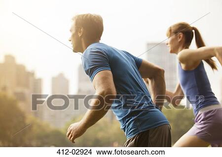 Picture - Couple running in urban park. Fotosearch