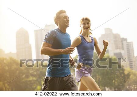 Couple running in urban park View Large Photo Image Stock Image - Couple running in urban park. Fotosearch