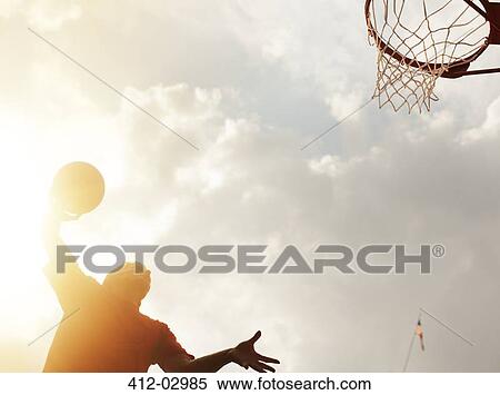 Man dunking basketball on court View Large Photo Image Stock Photography - Man dunking basketball on court. Fotosearch