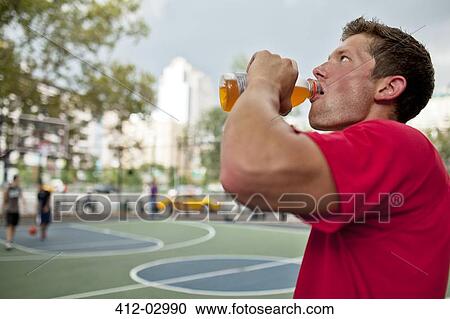 Man having sports drink court View Large Photo Image Stock Image - Man having sports drink court. Fotosearch