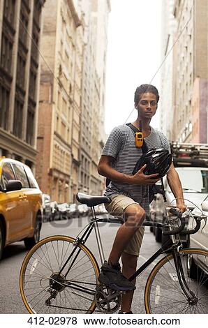Stock Photo - Man on bicycle on city street. Fotosearch