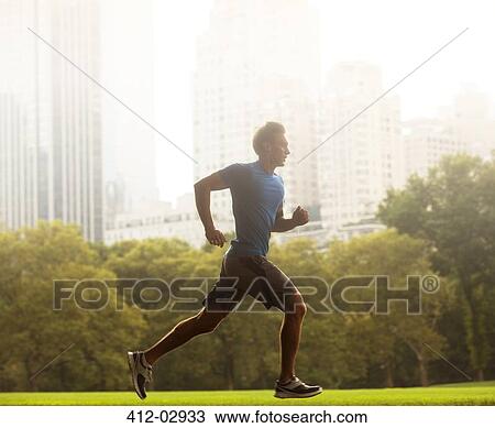 Stock Image - Man running in urban park. Fotosearch
