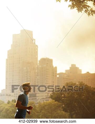 Stock Photo - Man running in urban park. Fotosearch