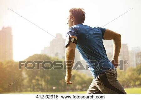 Man running in urban park View Large Photo Image Stock Photograph - Man running in urban park. Fotosearch