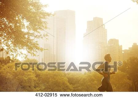 Man running in urban park View Large Photo Image Stock Photography - Man running in urban park. Fotosearch