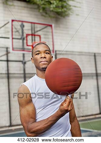 Man spinning basketball on finger View Large Photo Image Stock Photo - Man spinning basketball on finger. Fotosearch