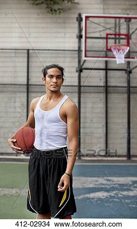 Man standing on basketball court View Large Photo Image Picture - Man standing on basketball court. Fotosearch