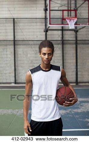 Man standing on basketball court View Large Photo Image Stock Image - Man standing on basketball court. Fotosearch